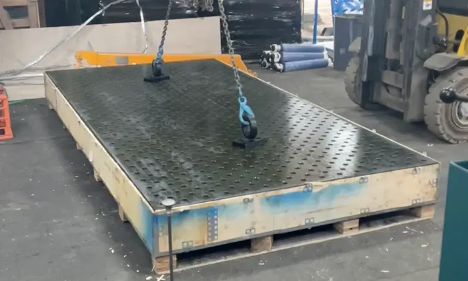 Lifting lugs used to lift a welding table top from its box